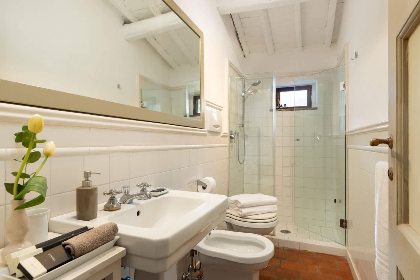 Villa Castellaro — an en-suite bathroom with a glass shower