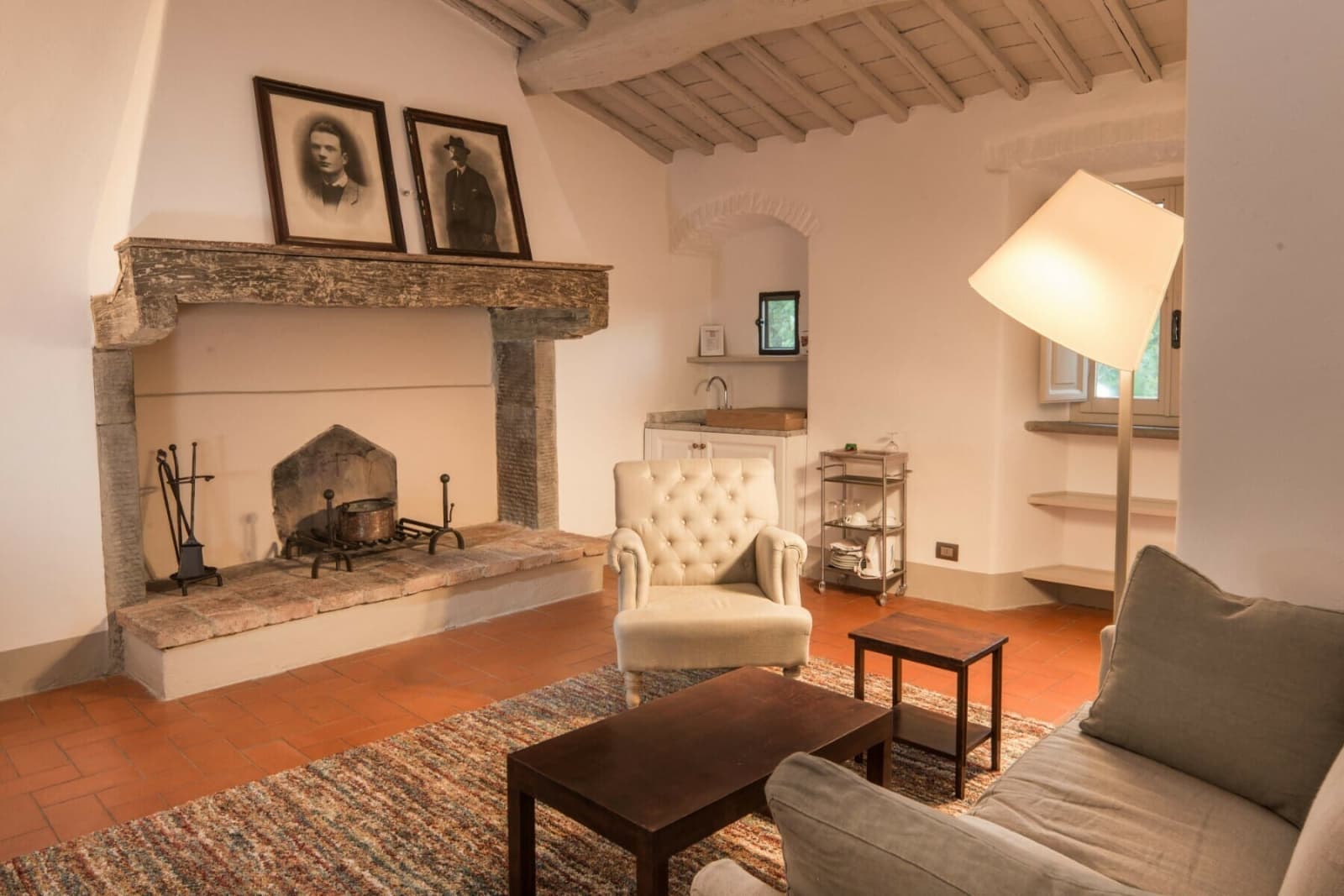 Casale Gherardi — a sitting room with stone fireplace