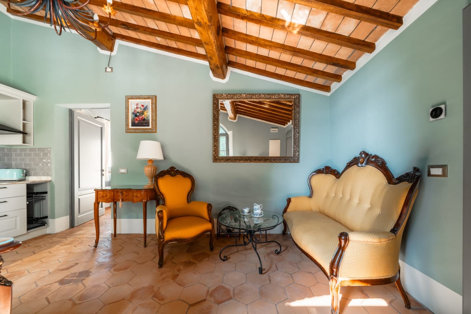 Villa Poggio d'Oro — a blue-walled sitting room with an antique sofa