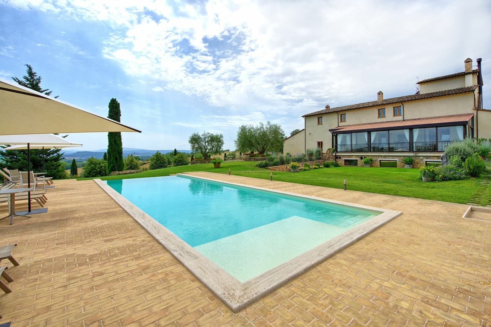 Tenuta La Barricaia — the pool and loungers below the villa