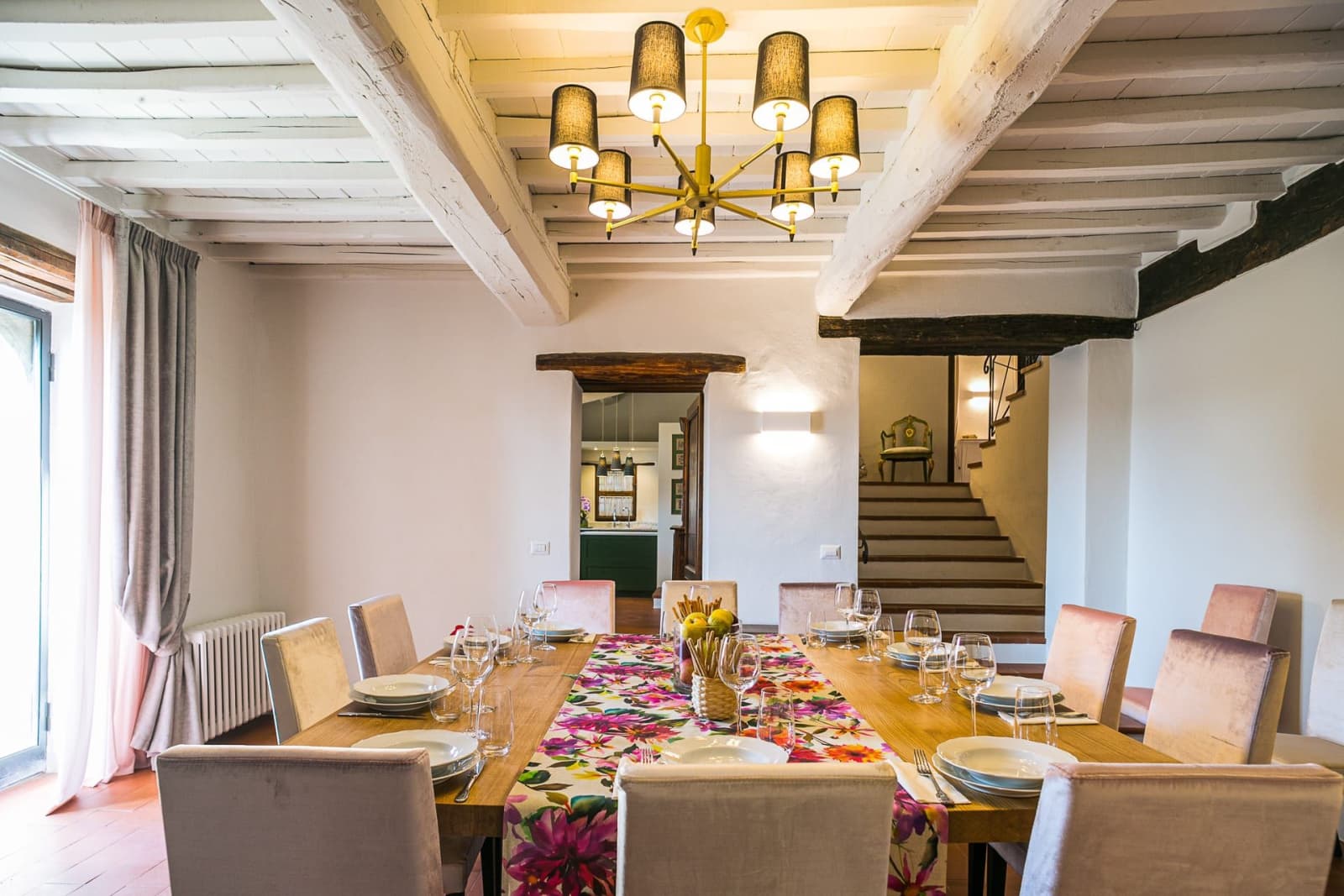 Casa dell'Erta — the dining room beneath a chandelier