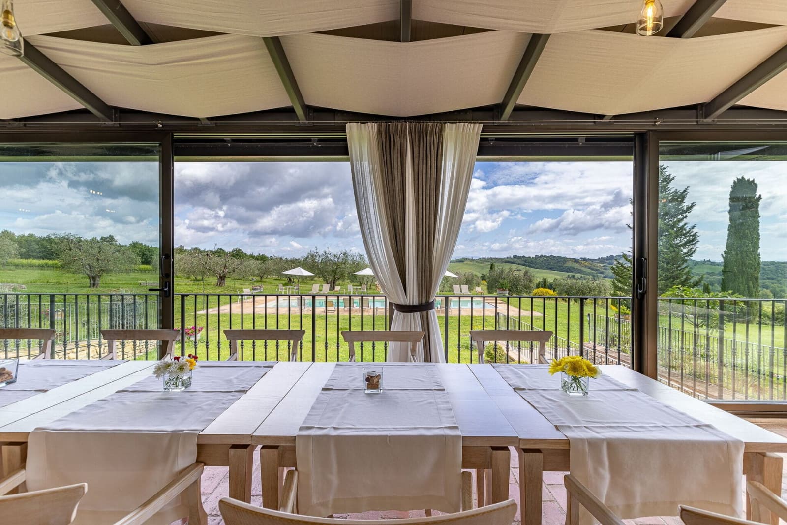 Tenuta La Barricaia — the glass-walled dining veranda, set for lunch