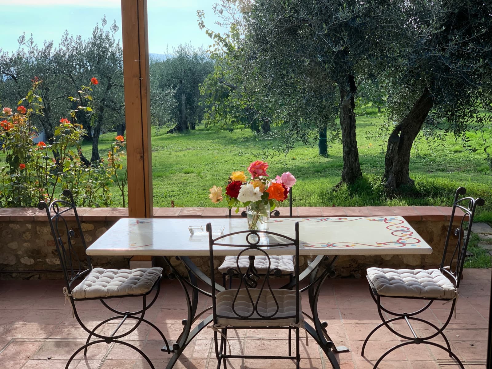 Casale Olivaio — a table on the patio among the olives