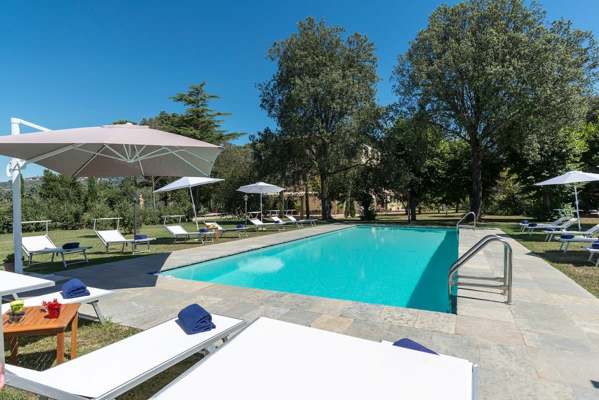 Villa della Cappella — the pool terrace with sun loungers