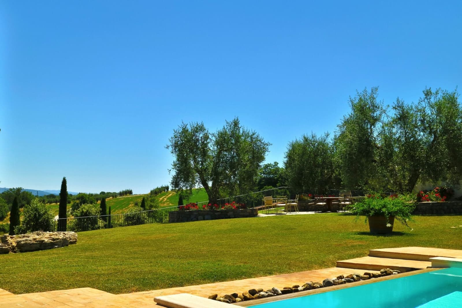 Tenuta La Barricaia — the lawn running down to the pool