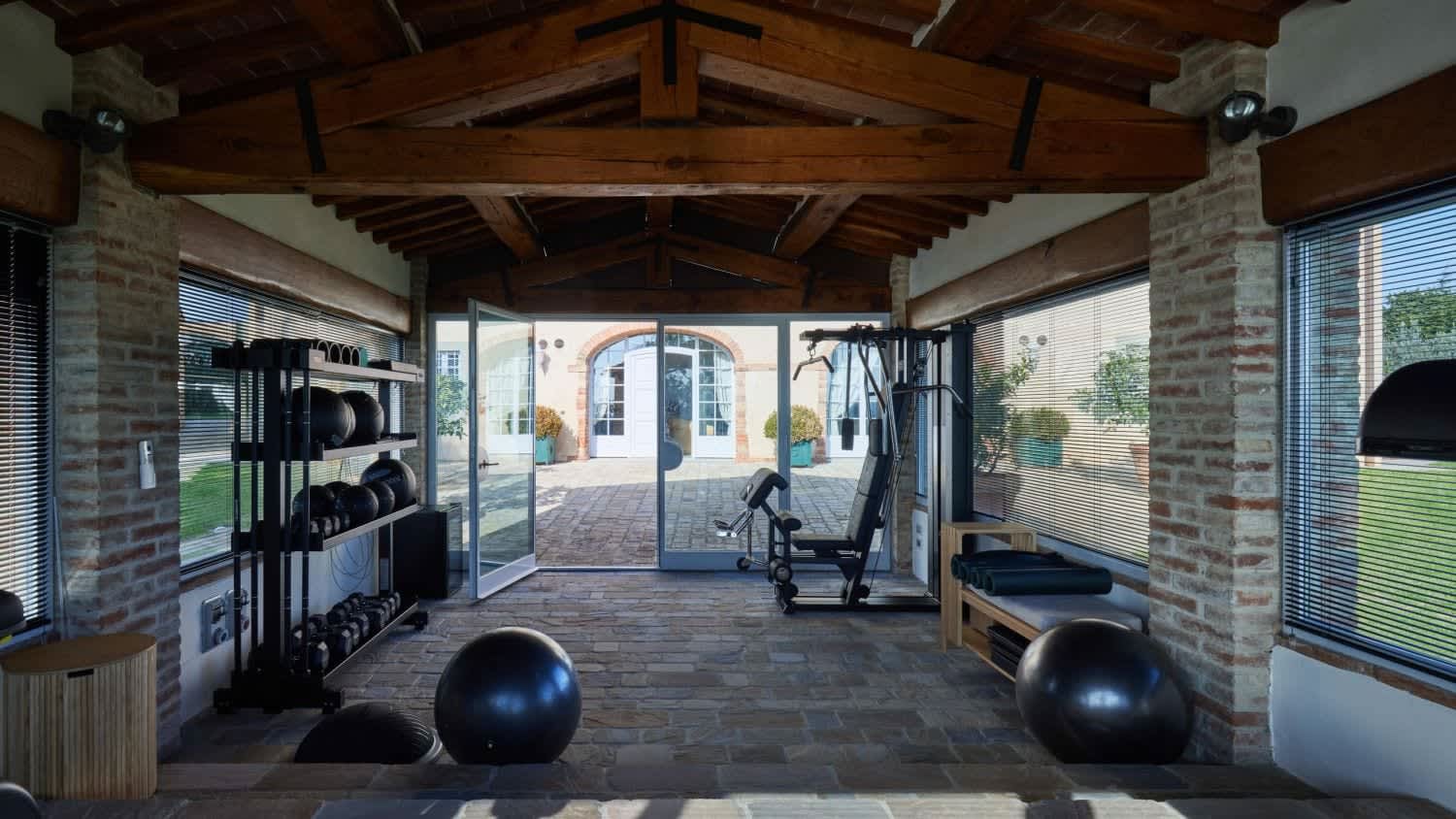 Villa Fornacella — the gym with the countryside beyond