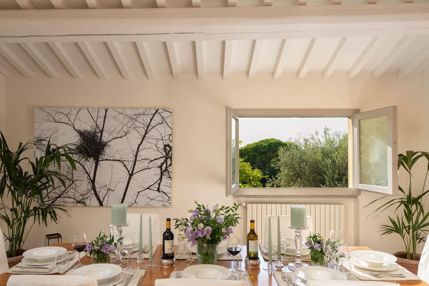 Casa Lilia — the dining table beneath a picture window onto the garden