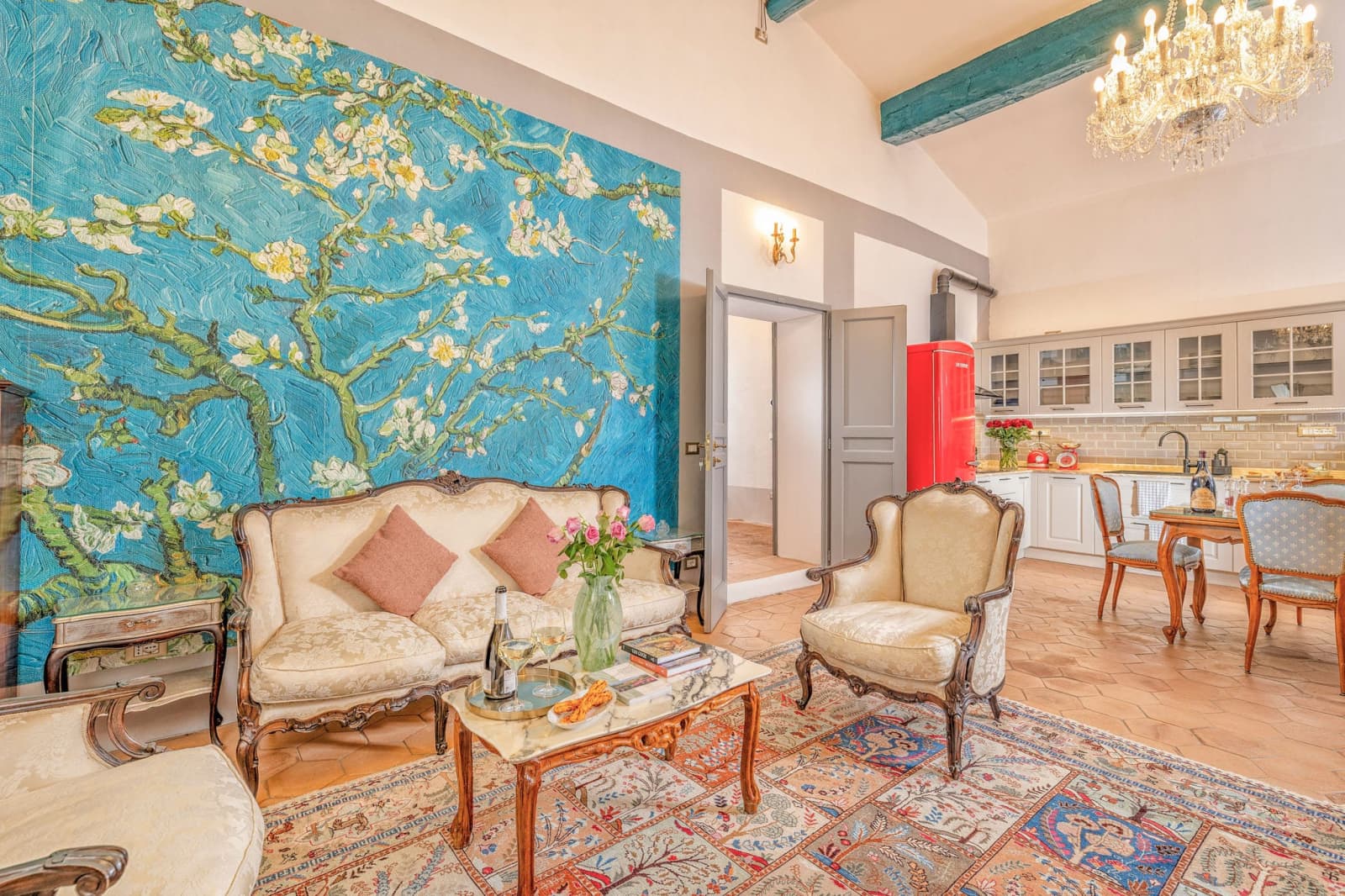 Villa Poggio d'Oro — a living room beneath an almond-blossom mural