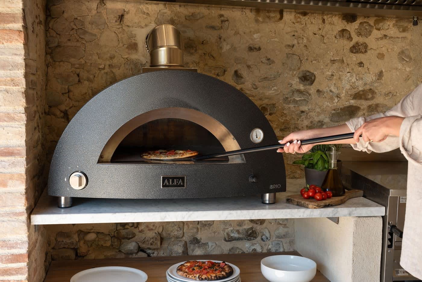 Villa Castellaro — a pizza coming out of the wood-fired oven