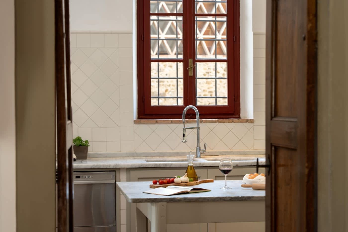 Villa Castellaro — the kitchen sink beneath a leaded window
