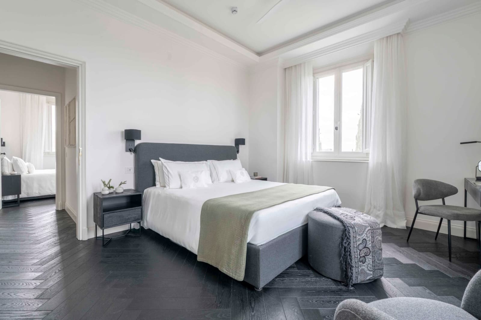 Tenuta Belvedere Estate: Tenuta Belvedere — a villa bedroom opening onto a connecting room