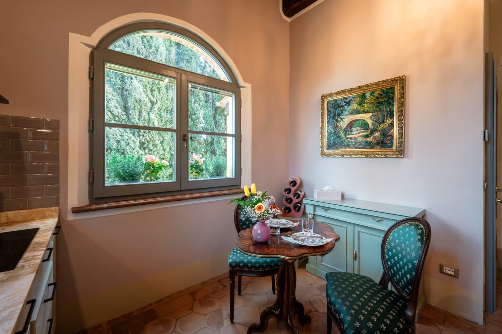 Villa Poggio d'Oro — a dining nook beneath an arched window
