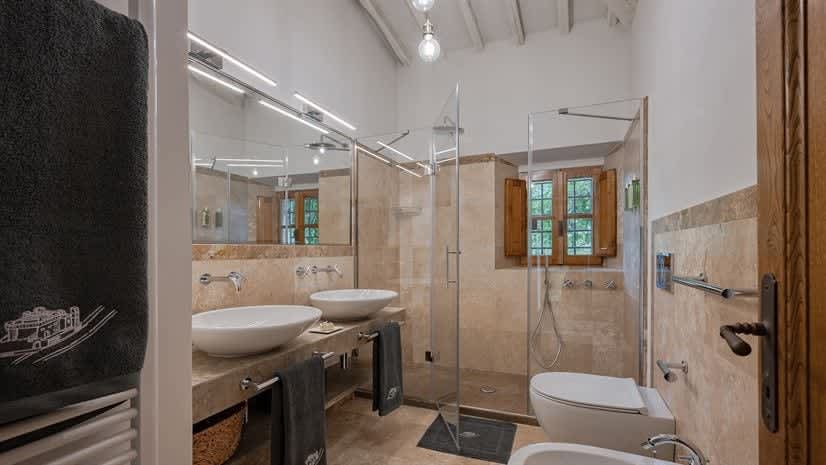 Borgo delle Vigne — a bathroom with double vanity and walk-in shower