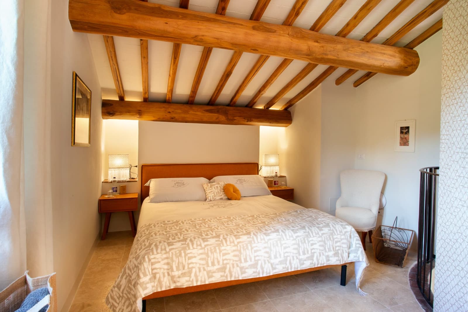 Casa Pernicella — a bedroom beneath chestnut beams
