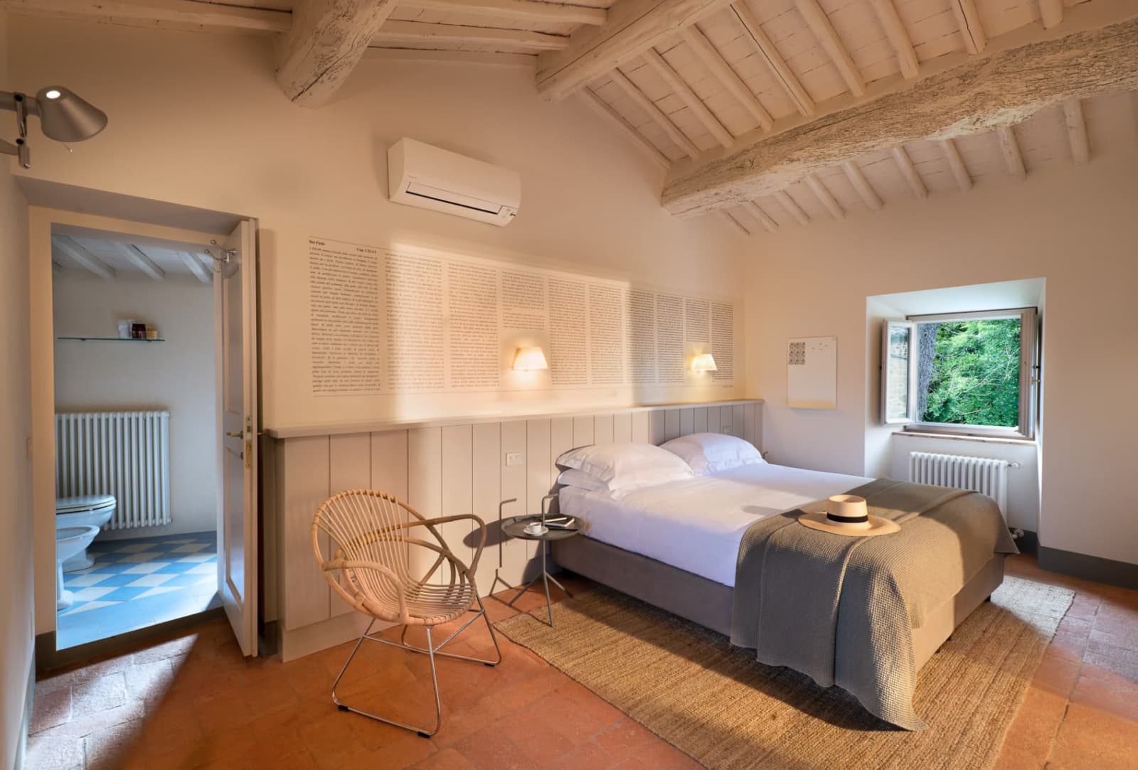 Villa Erbavoglio — a bedroom with beamed ceiling and en-suite bathroom