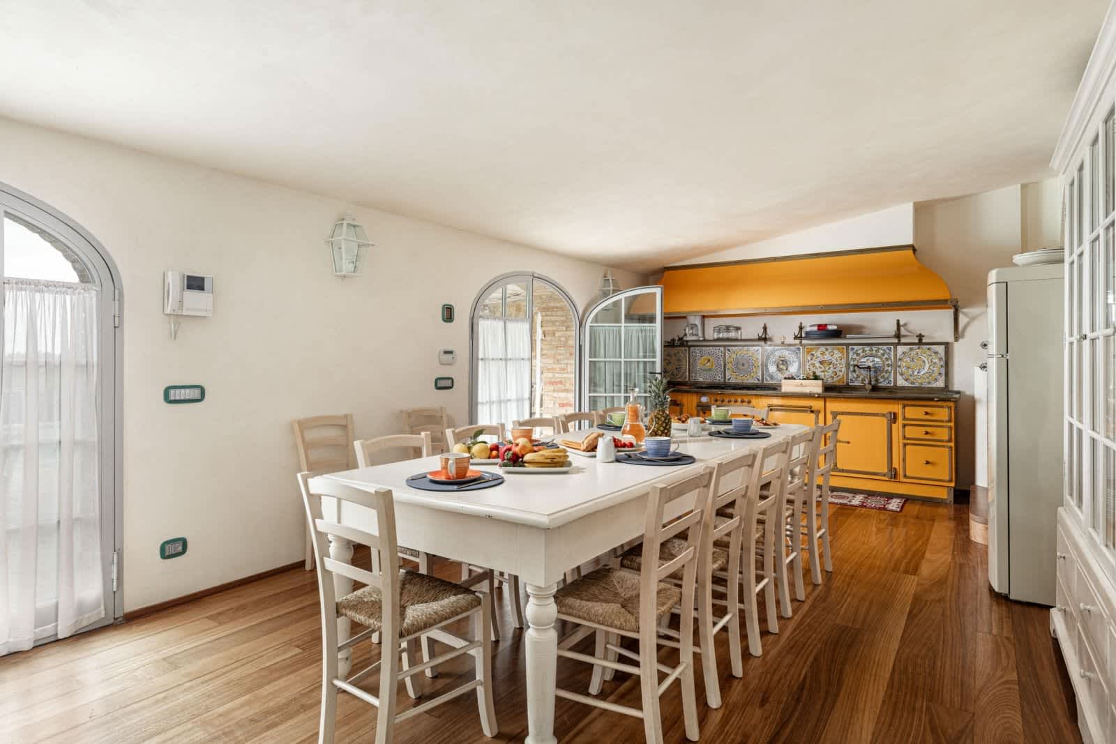 Villa Fornacella — the yellow pool kitchen and its table