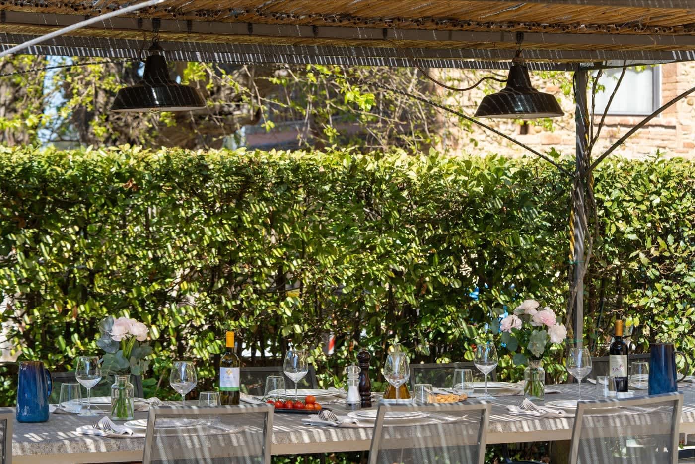Villa Castellaro — the pergola table laid for dinner