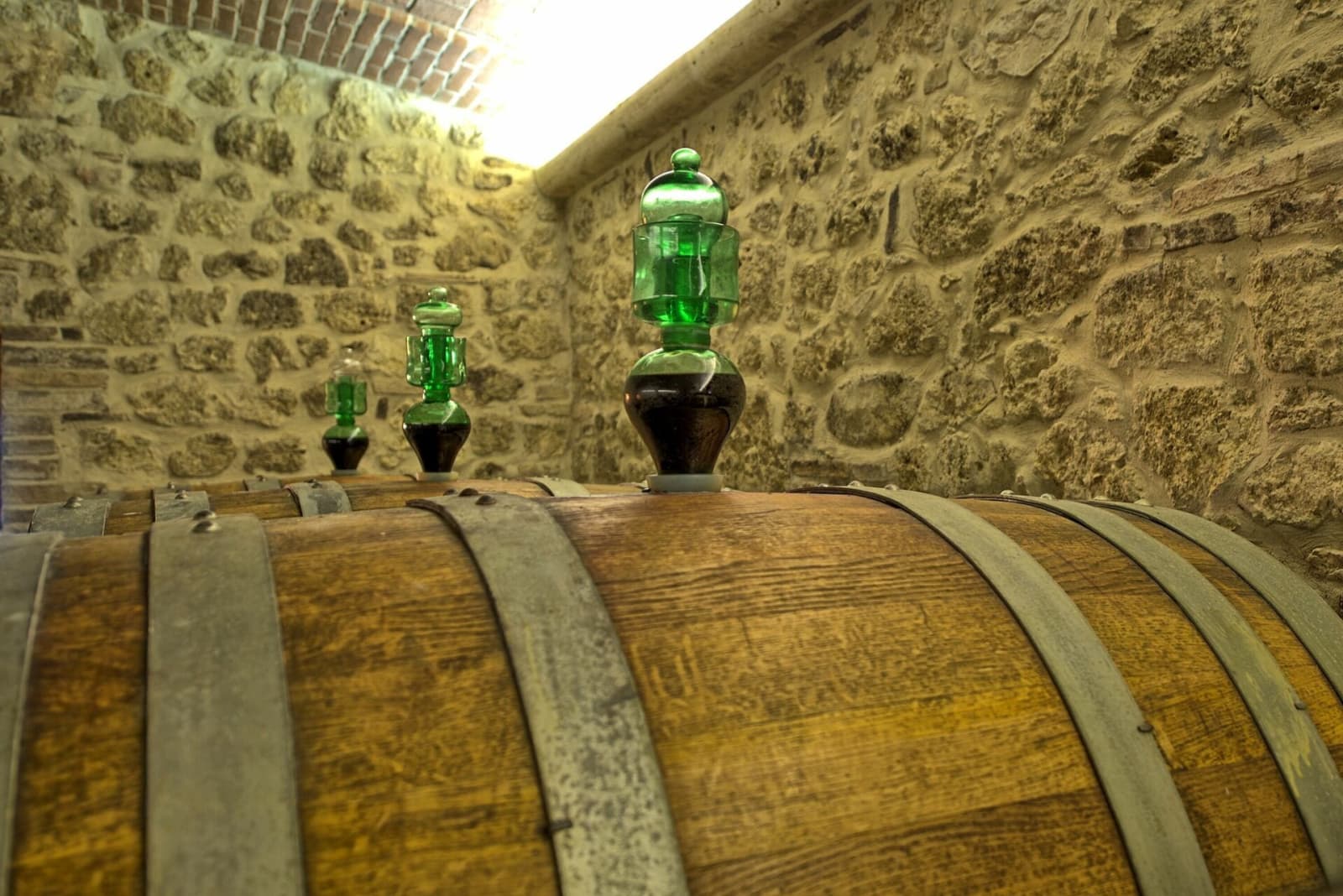 Tenuta La Barricaia — a barrel against the cellar's stone wall