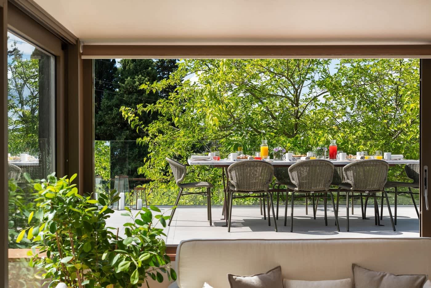 Casa Lilia — the terrace table under the trees