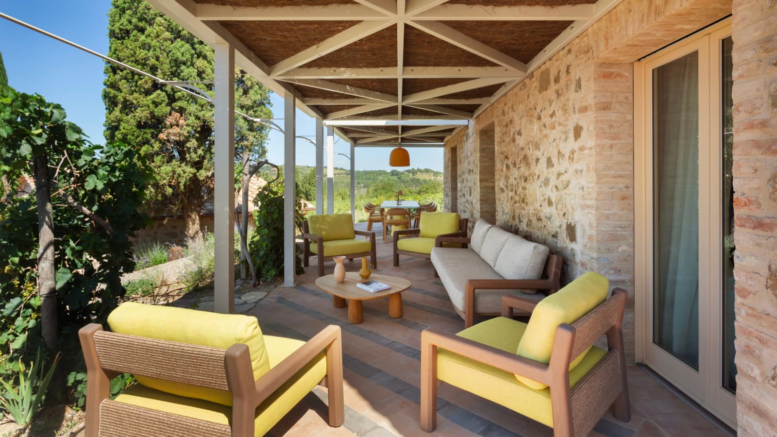 Podere Mastrojanni — a covered terrace with lounge seating