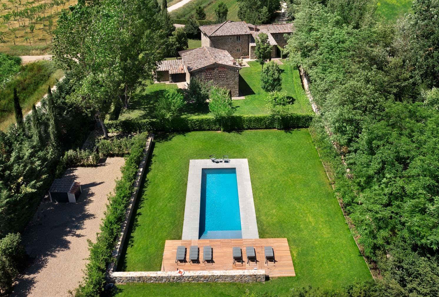 Villa Erbavoglio — aerial view of the garden pool among the olive groves