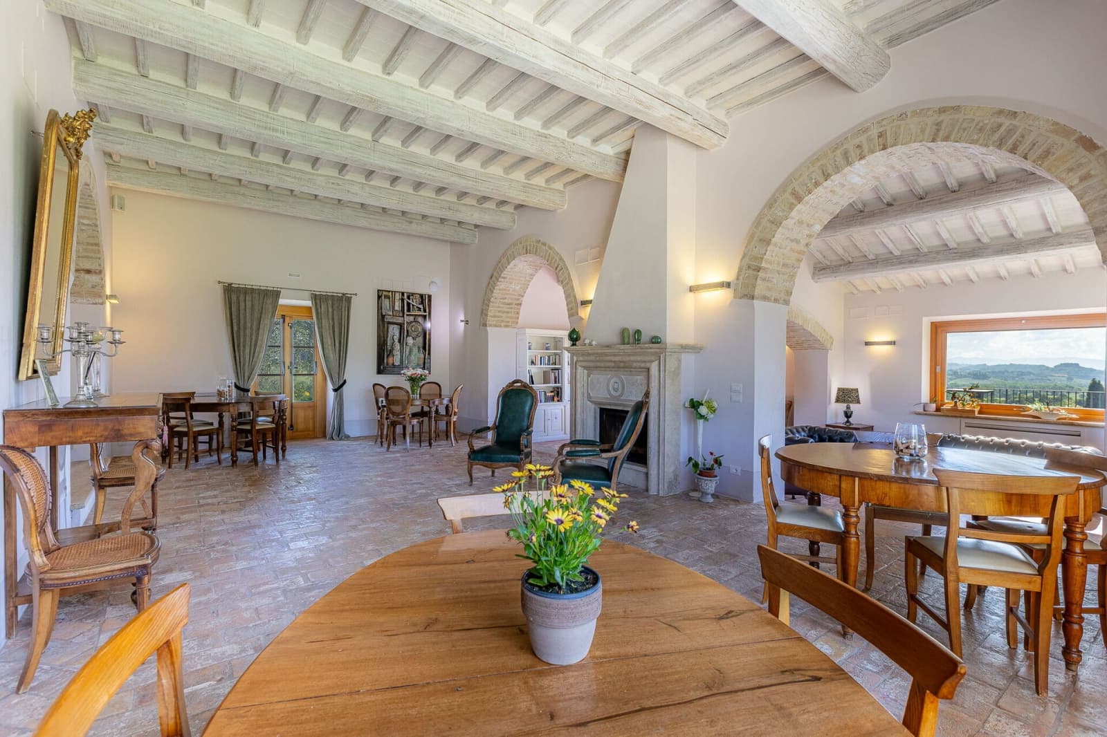 Tenuta La Barricaia — the living room's dining table beneath stone arches