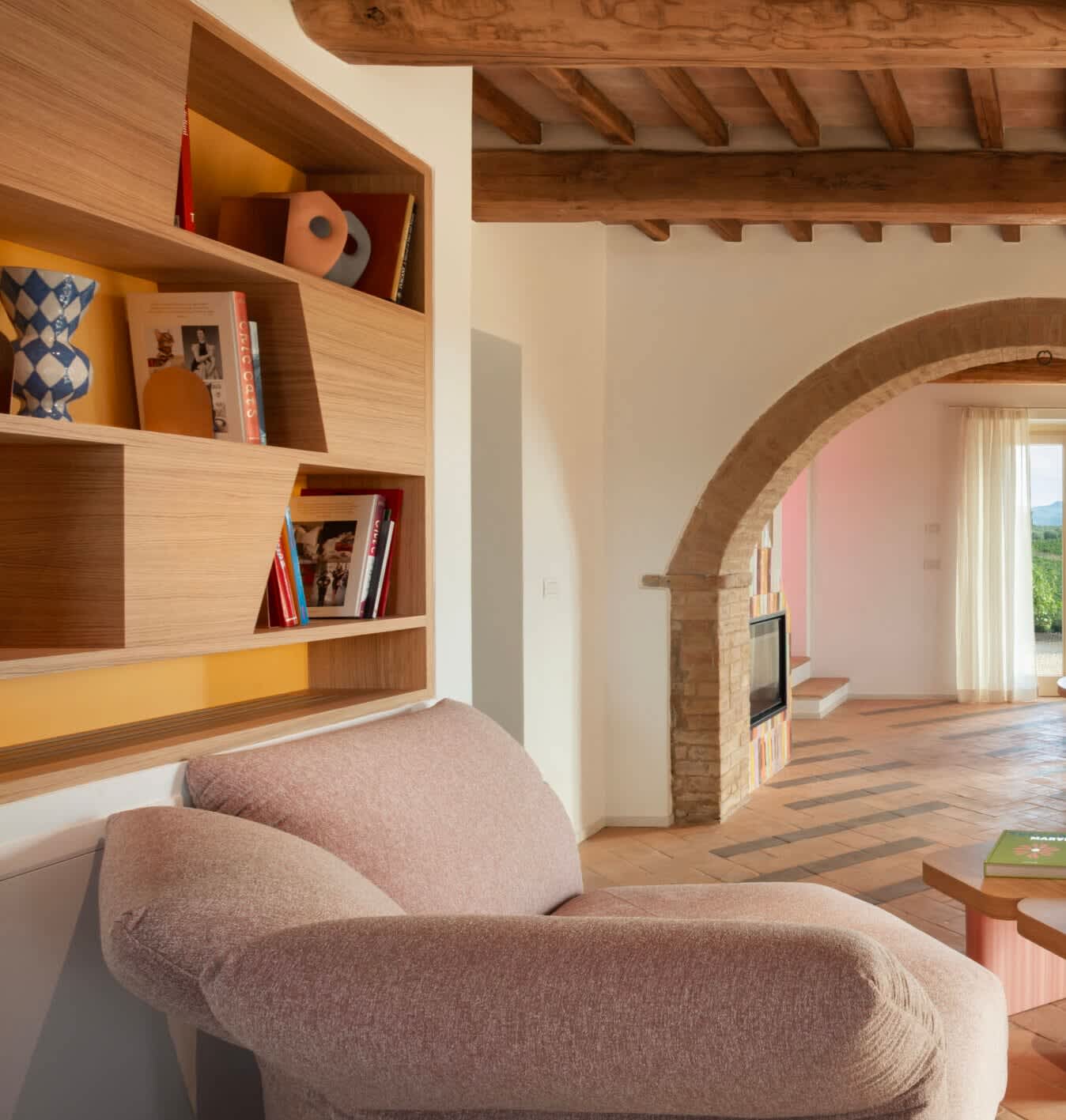 Podere Mastrojanni — a reading nook opening to the fireplace room