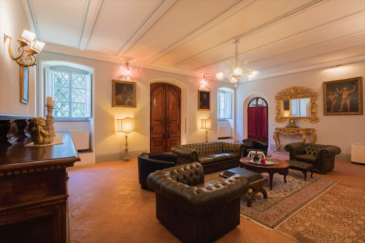 Villa della Cappella — a second sitting room with dark leather Chesterfields