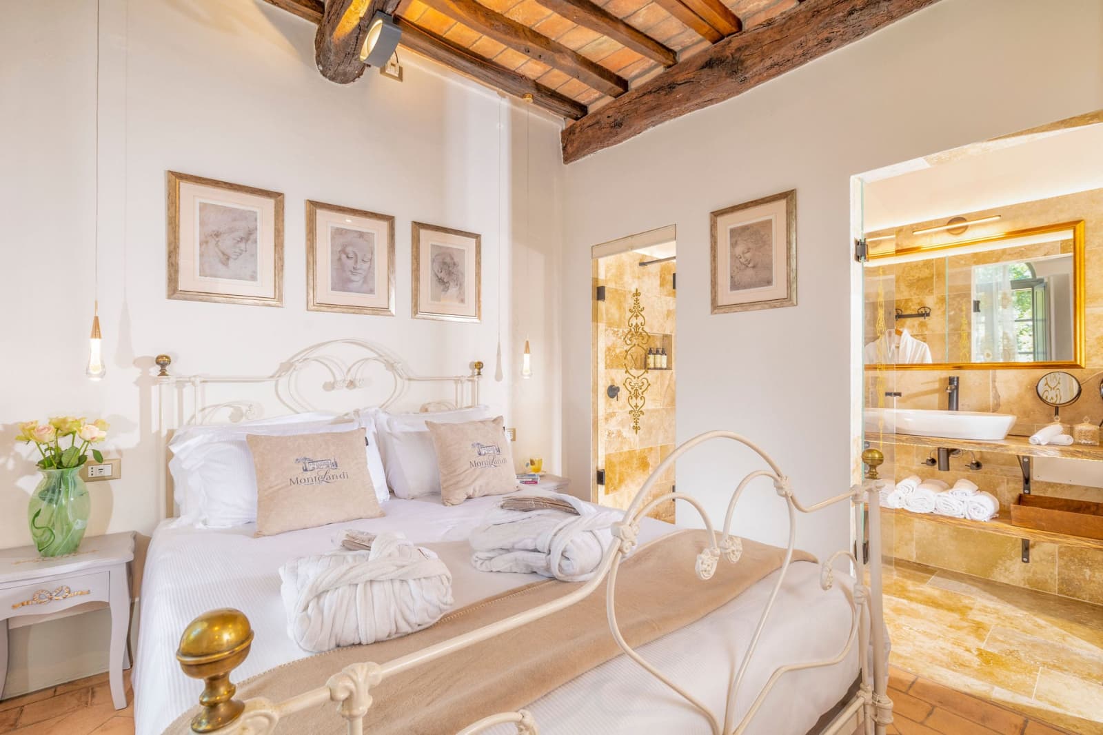 Villa Poggio d'Oro — a white bed beneath framed botanical prints