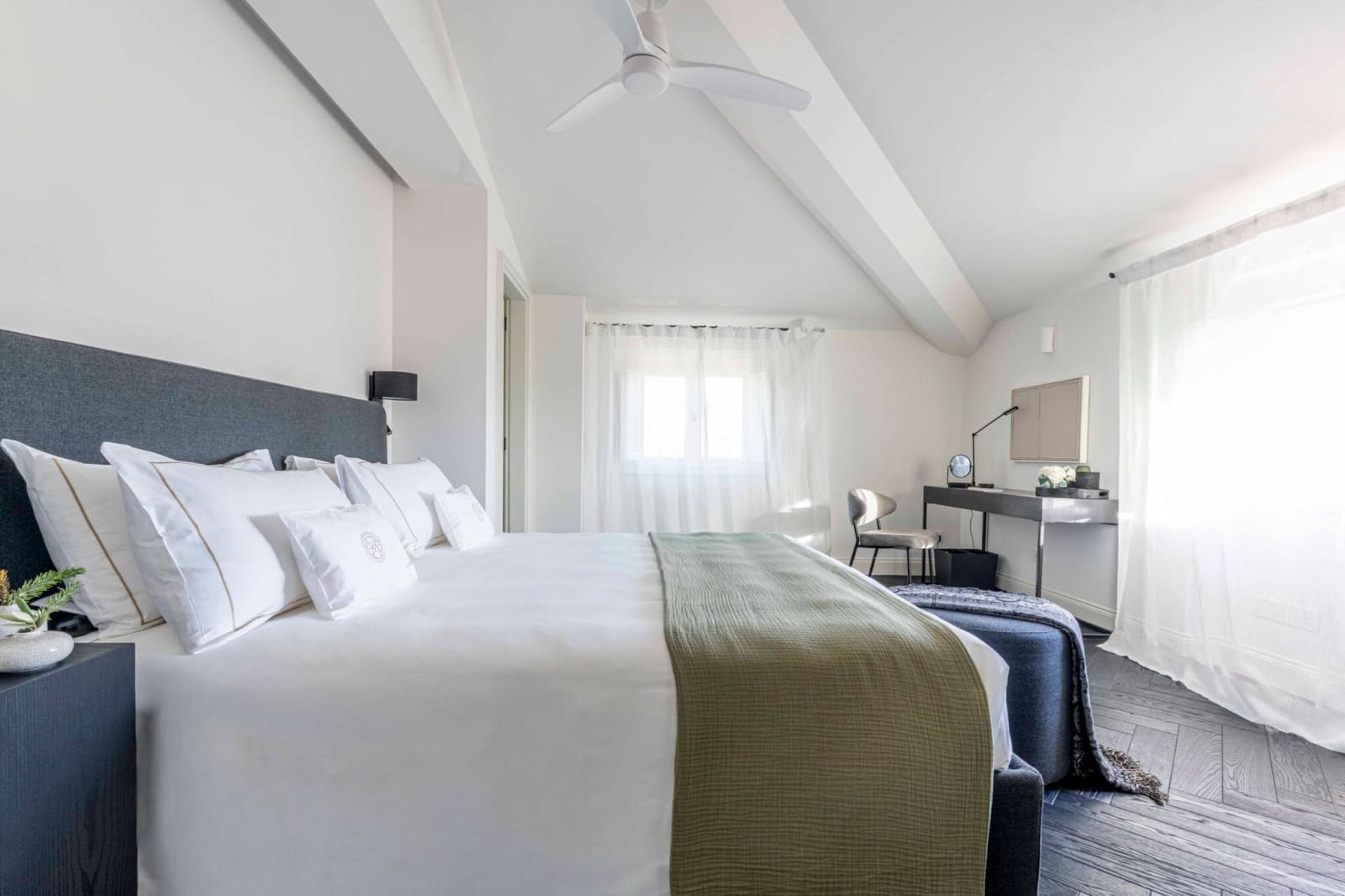 Tenuta Belvedere Estate: Tenuta Belvedere — a suite bedroom with a linen throw