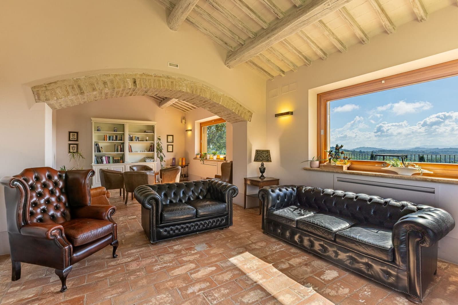 Tenuta La Barricaia — leather sofas beside a picture window onto the hills