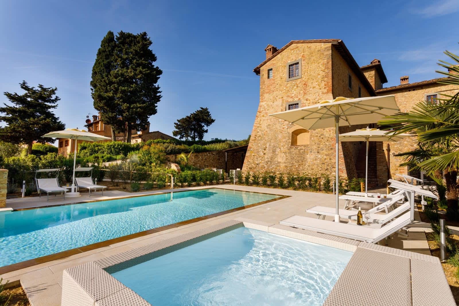 Podere Pianoro — the stone tower above the pool