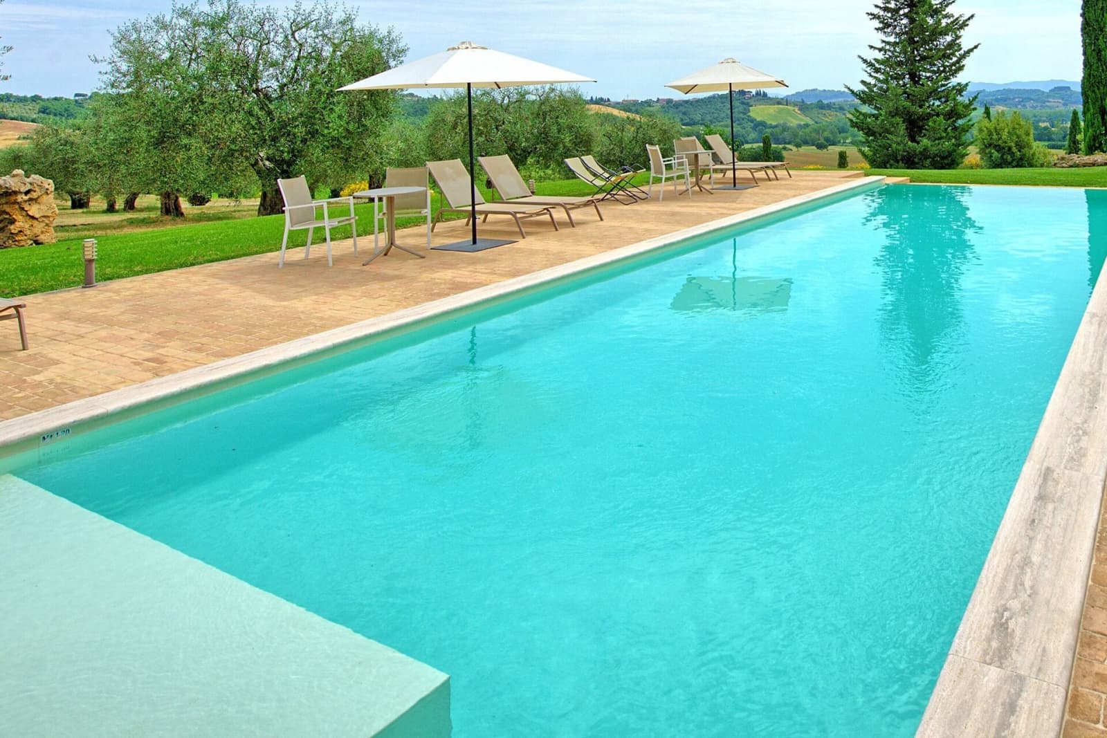 Tenuta La Barricaia — the infinity pool, with loungers and umbrellas