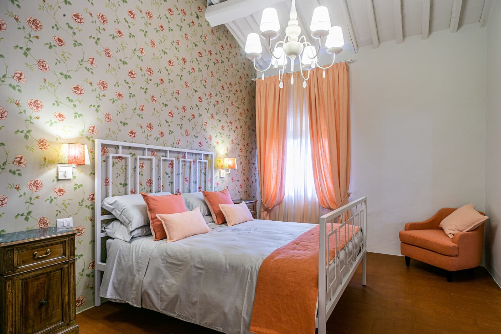 Casa dell'Erta — a bedroom with peach curtains and a chandelier
