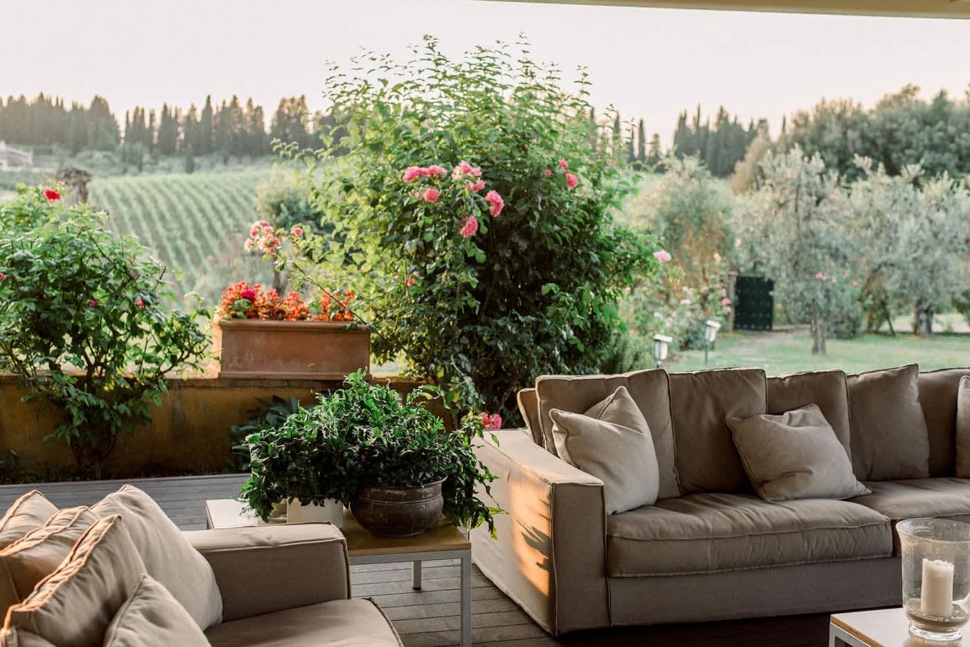 Villa Castellaro — outdoor sofas among roses on the terrace