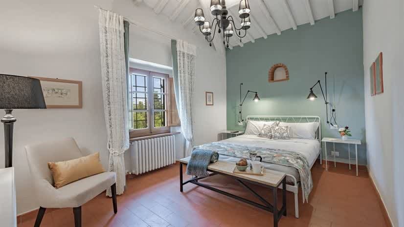 Borgo delle Vigne — a bedroom with a teal feature wall