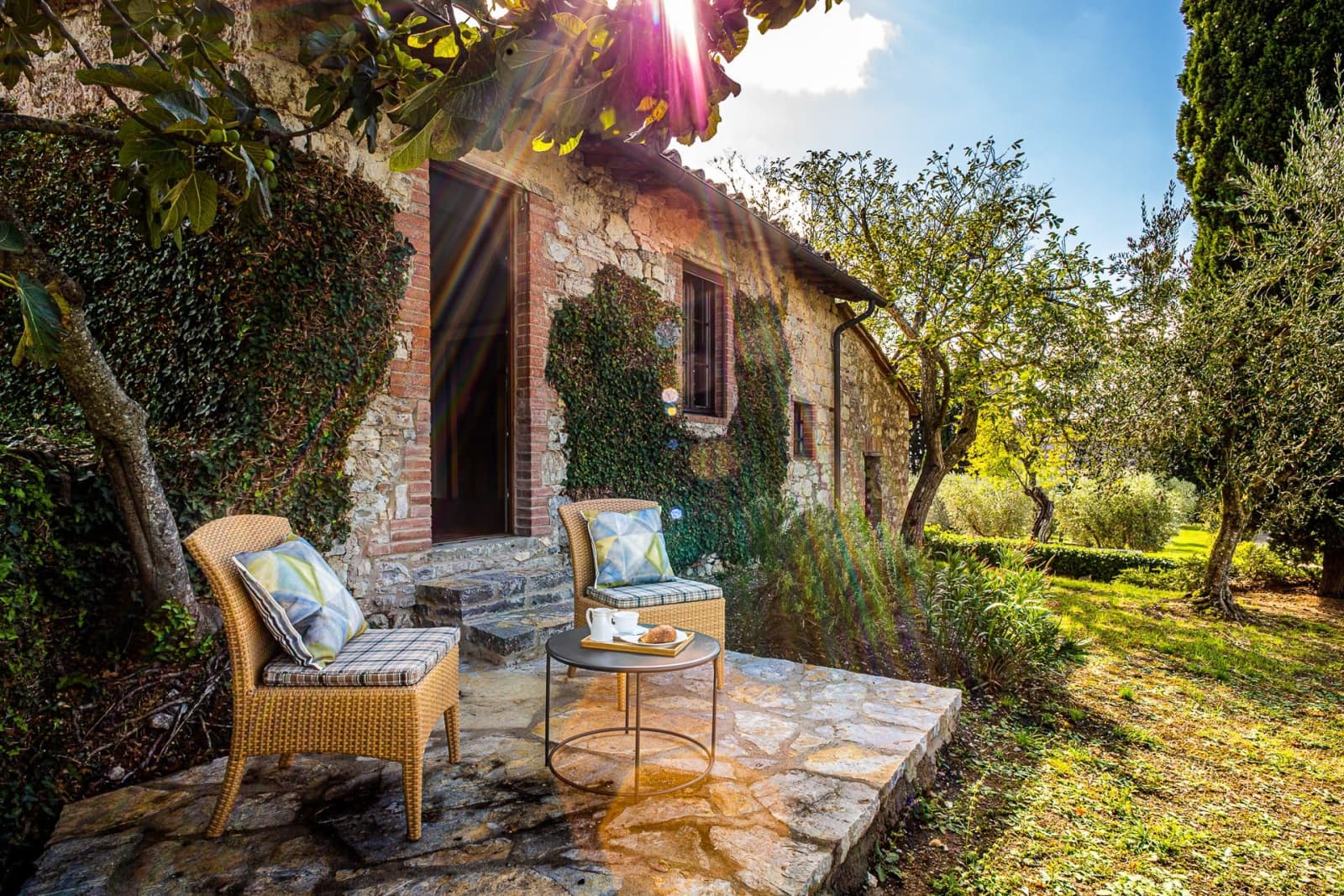 Casa dell'Erta — a chair on the terrace by the stone wall