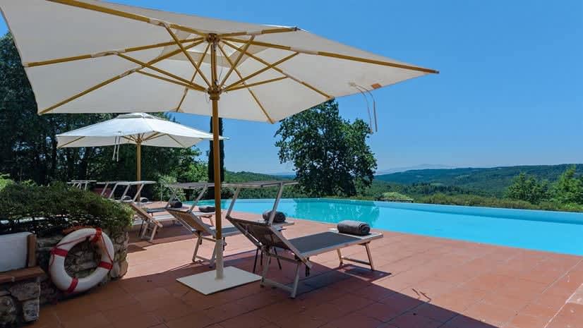 Borgo delle Vigne — poolside loungers over the Chianti hills