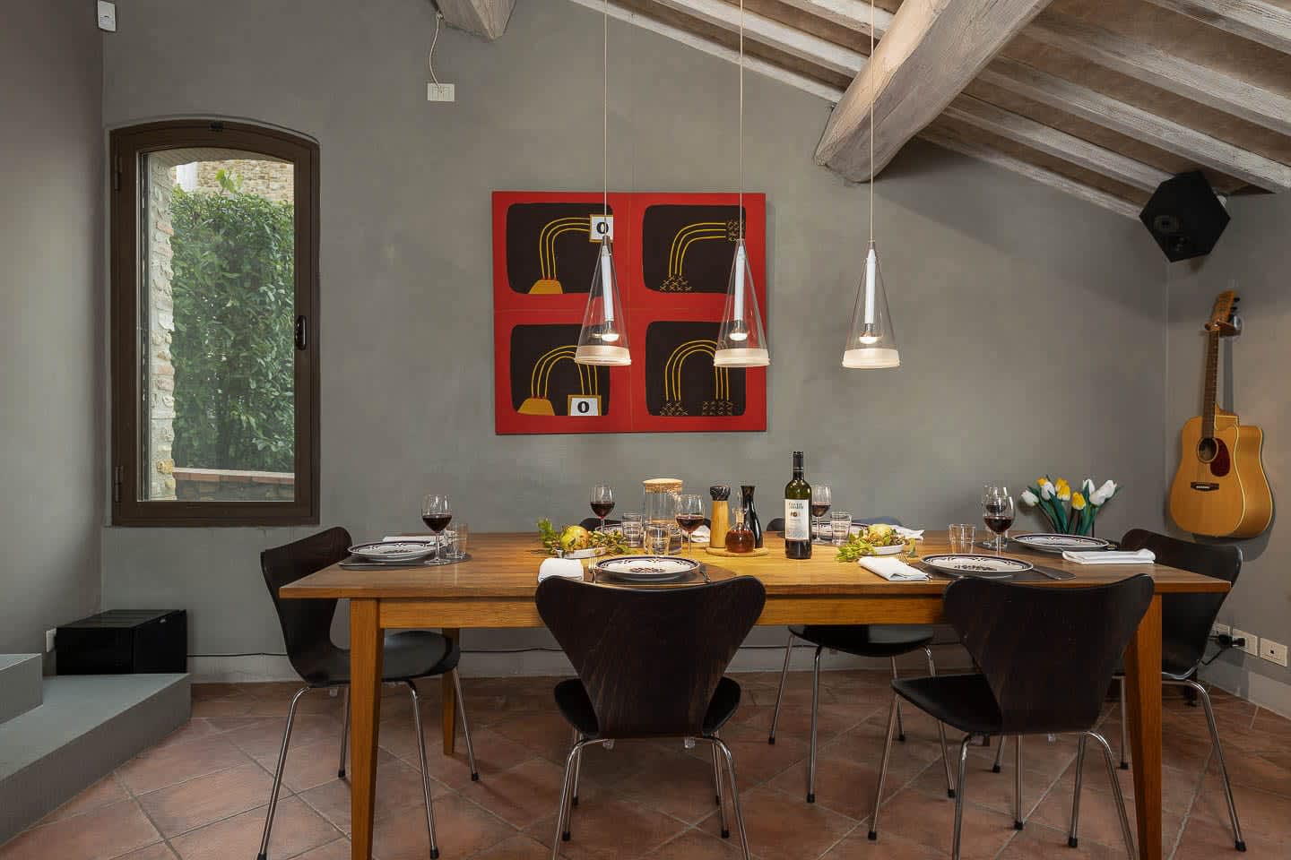 Casale Olivaio — the dining table with red art