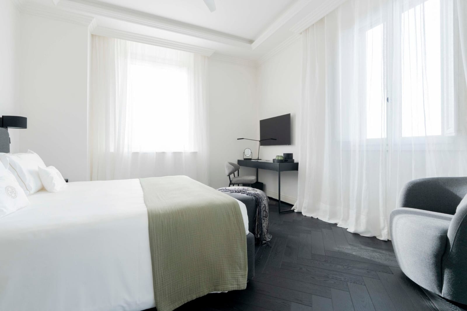 Tenuta Belvedere Estate: Tenuta Belvedere — a villa bedroom with a sage-green throw