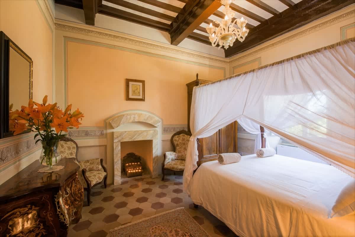 Villa della Cappella — a bedroom with its own fireplace
