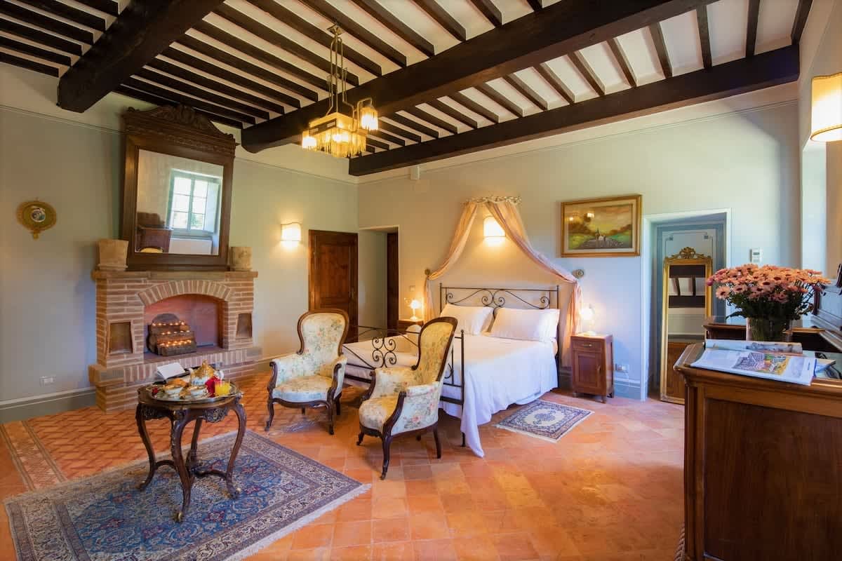 Villa della Cappella — a beamed-ceiling bedroom