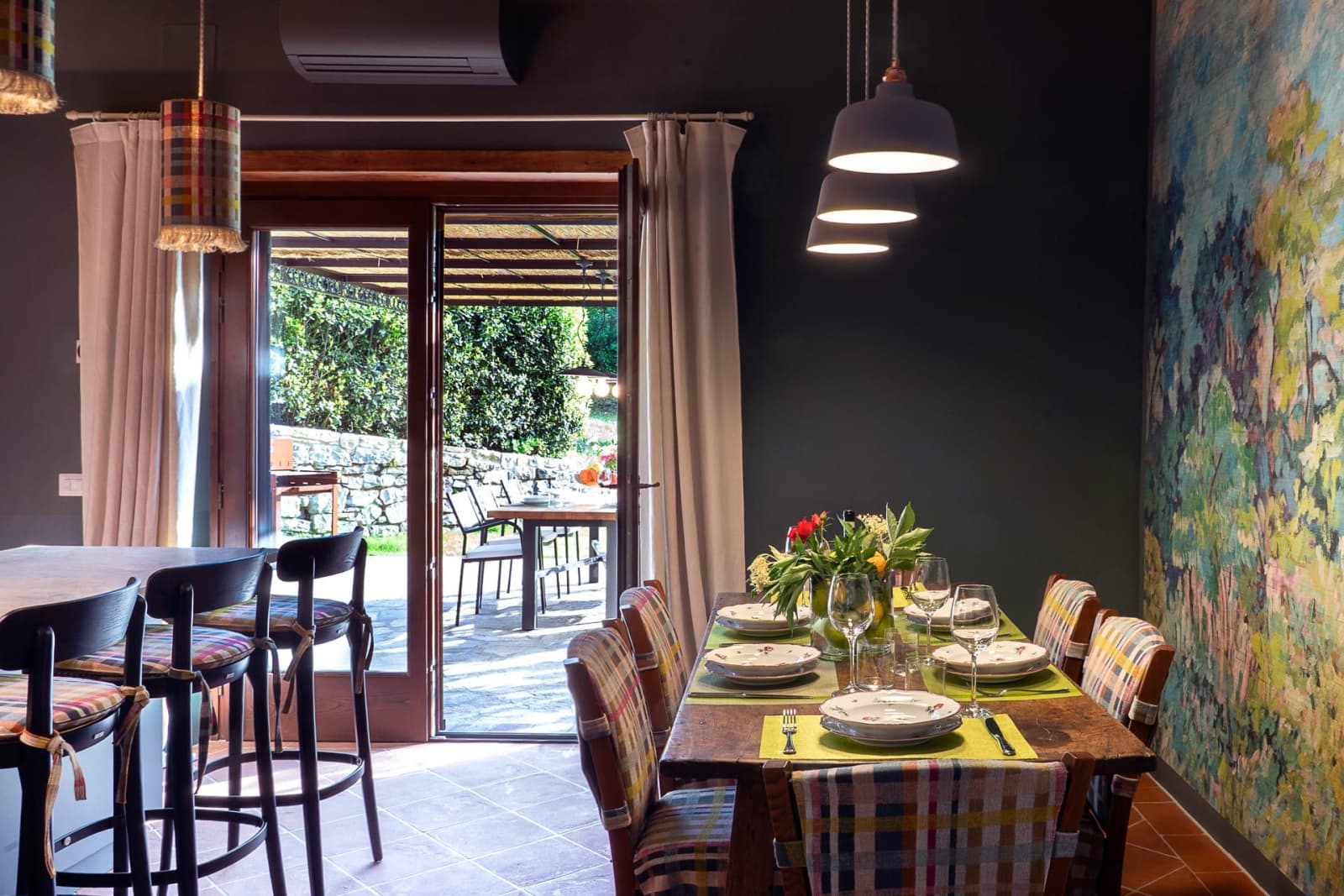 Casa Pernicella — the dining table, doors open to the pergola