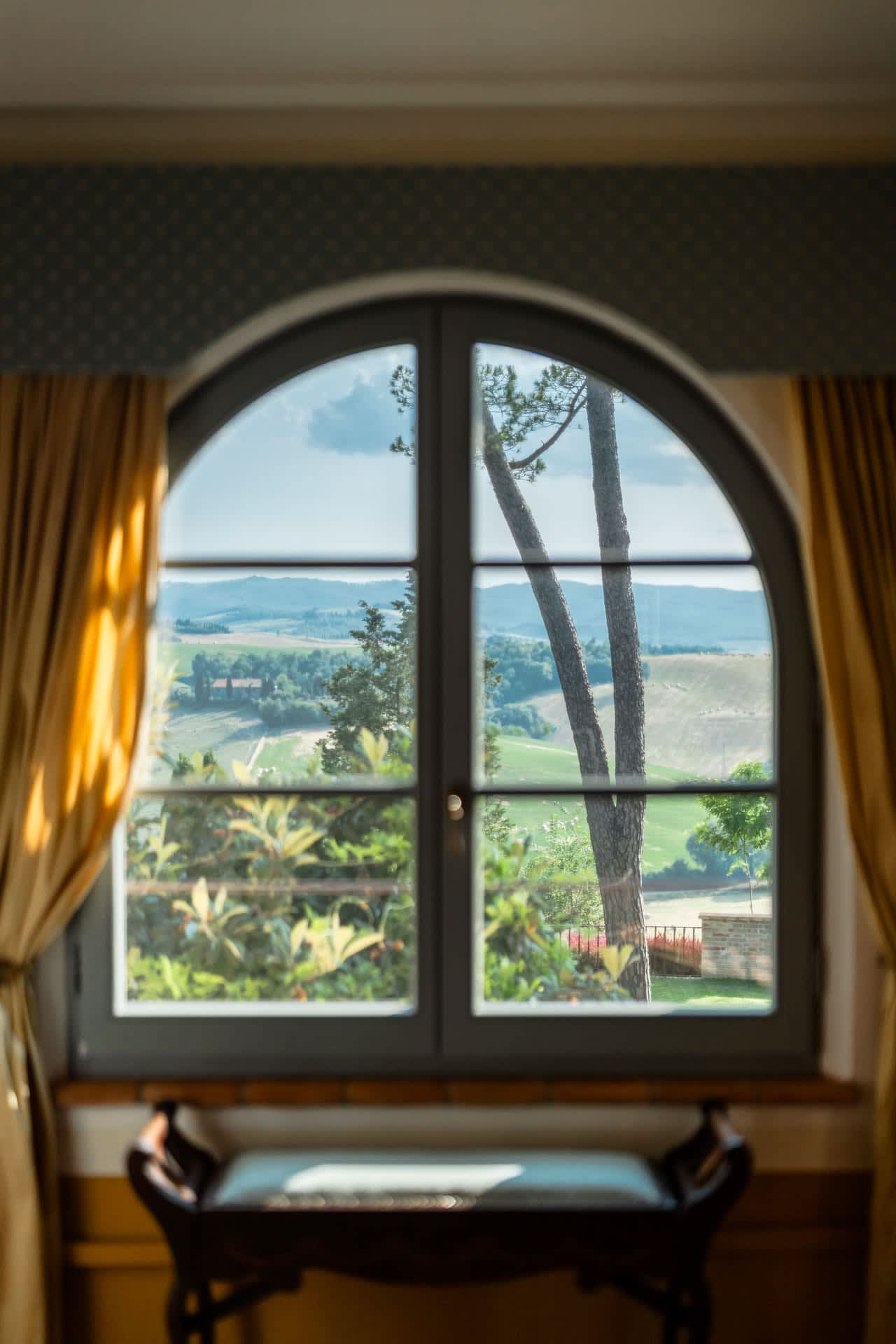 Villa Poggio d'Oro — an arched window over the hills