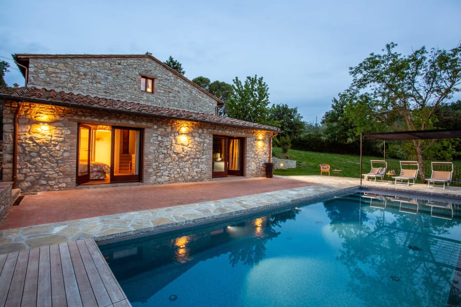 Casa Pernicella — the stone house above its infinity pool at dusk