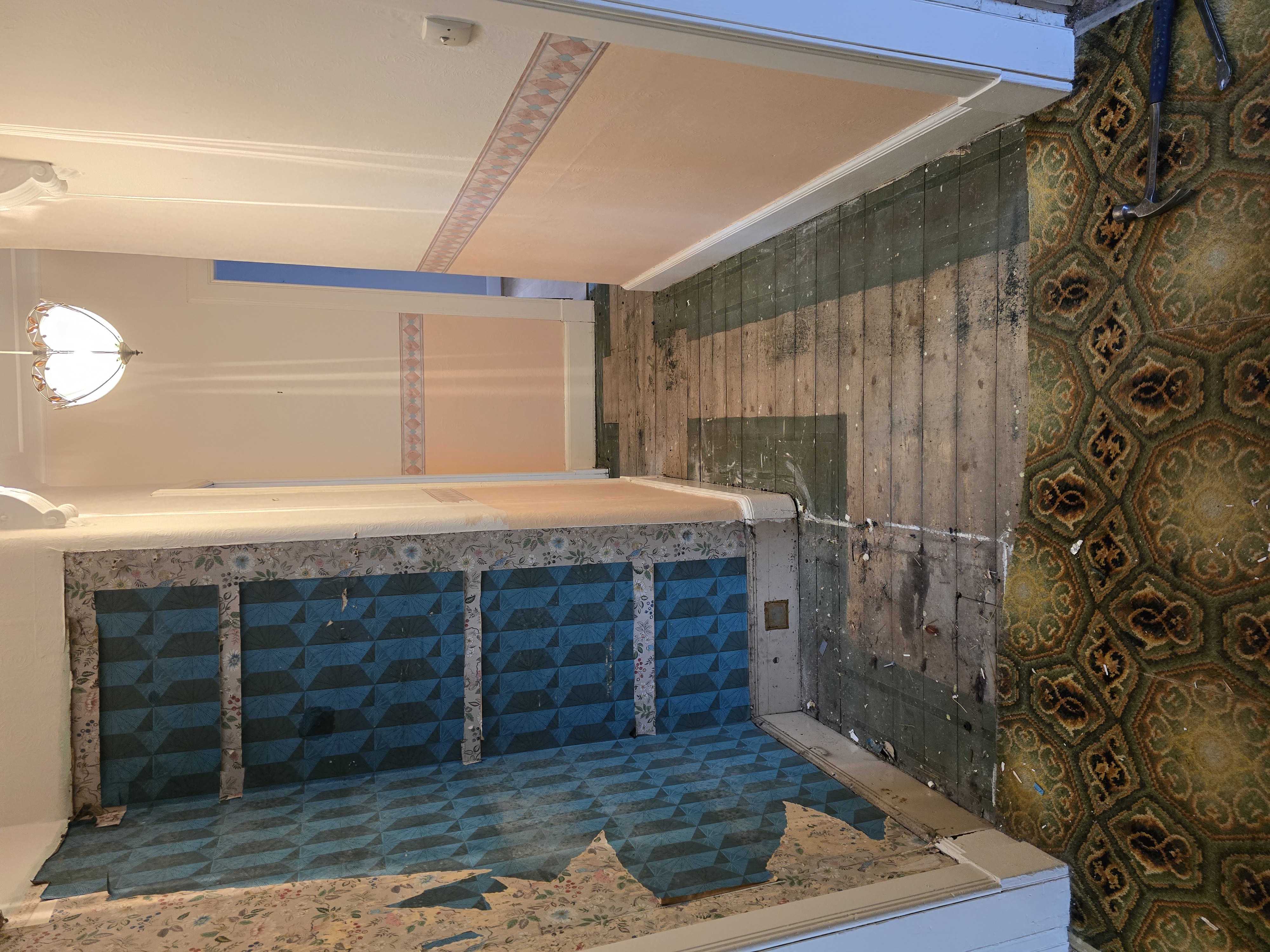 Property hallway before refurbishment — stripped wallpaper and old flooring, Wishaw flat renovation by Murphy Project Management