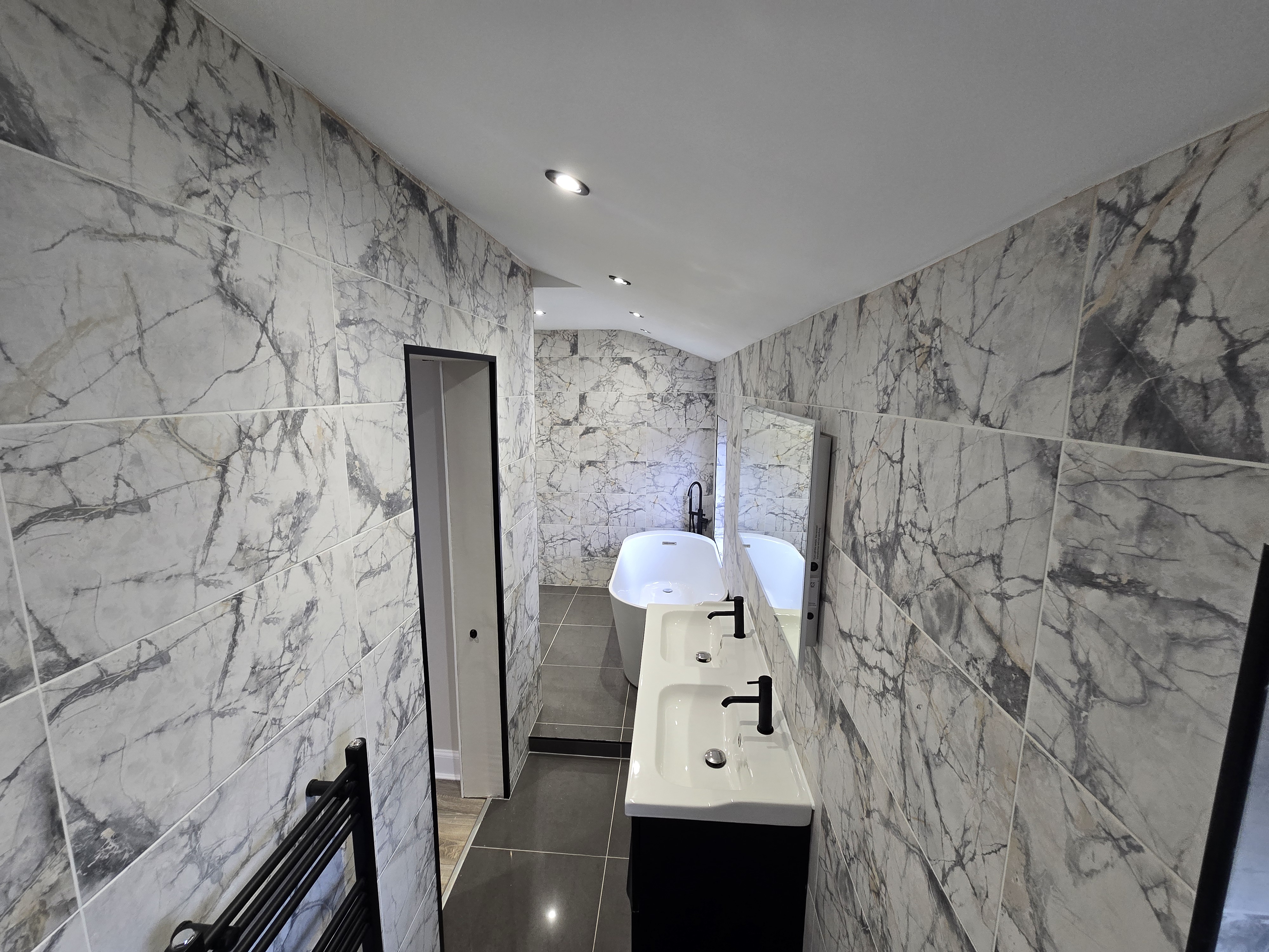 Freestanding bath with black floor-standing tap — high specification bathroom renovation, investor refurbishment Scotland