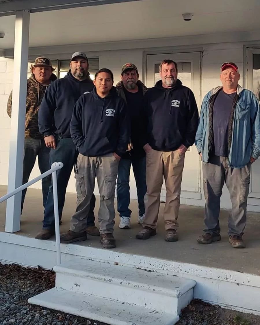 The Rosewood Plumbing crew of six technicians outside the Goldsboro office
