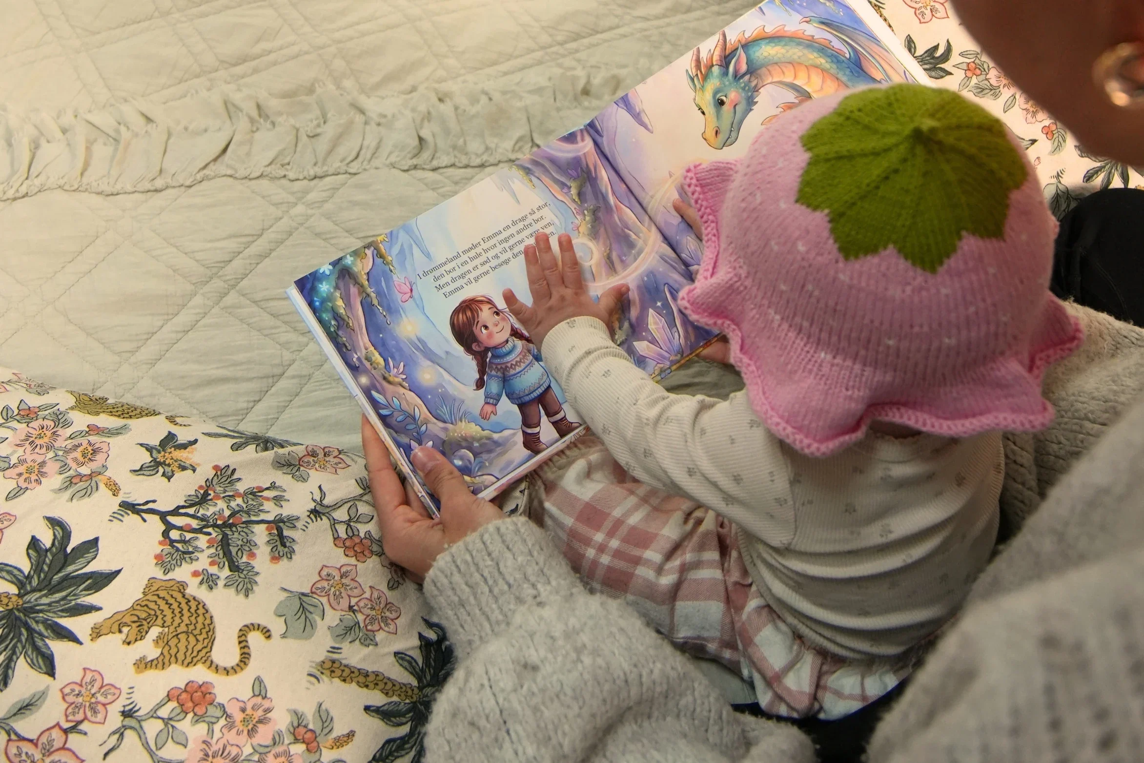 A child turning the pages of their personalised book and looking at the illustrations.