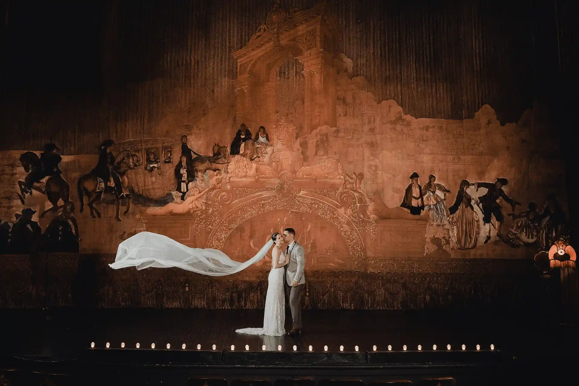 bride kissing the groom with her veil at wedding ceremony at the Los Angeles theater